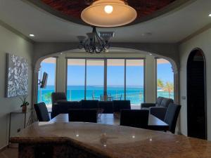 a dining room with a table and a view of the ocean at ESMERALDA B-201 in Puerto Peñasco