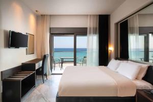 Rúm í herbergi á Tridente Mare Apart Hotel