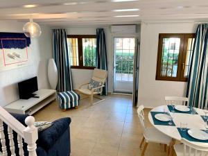 a living room with a couch and a table at CASA DUPLEX BUNGALOW Dénia in Denia