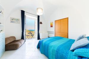 a bedroom with a bed and a view of the ocean at Charming House in Amalfi