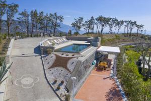 an aerial view of a house with a swimming pool at Amore Rentals - Villa Ligea in SantʼAgata sui Due Golfi