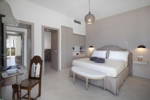 a bedroom with a bed and a table and a desk at Amore Rentals - Villa Ligea in SantʼAgata sui Due Golfi +67 photos