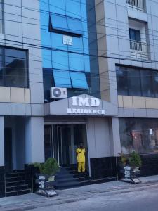 um homem está de pé na porta de um edifício em IMD Residence em Douala
