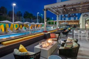 a resort with a pool and tables and chairs at Hyatt House Tampa Airport/Westshore in Tampa