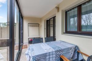 a room with a table and some windows at Appartement Martrois - Welkeys in Villers-sur-Mer
