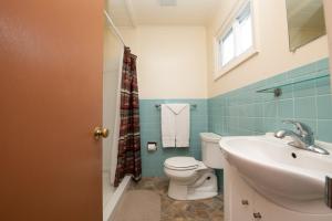 baño con lavabo y aseo y ventana en Shore Meadows Lodge LLC, en Lake George