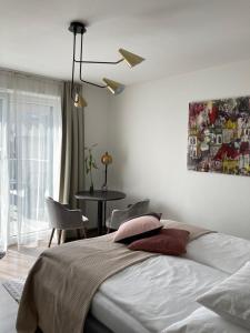 a bedroom with a bed and a table with chairs at Kal's Studio Apartment Salzburg in Salzburg