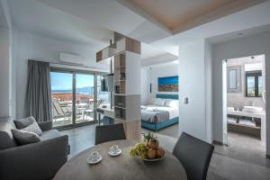 a living room with a table and a bedroom at Villa Diktynna in Hersonissos