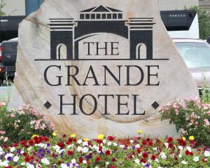 a sign for a grand hotel in a field of flowers at Mountaineer Casino Resort in New Cumberland