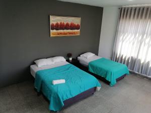 Postel nebo postele na pokoji v ubytování Suite Trujillo
