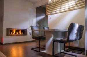 a dining room with a table and a fireplace at Villa Kap in Zagreb