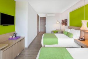 Ένα ή περισσότερα κρεβάτια σε δωμάτιο στο Hotel Bari Bucaramanga