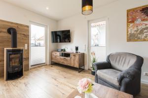 a living room with a couch and a fireplace at Naturpark-5 Sterne Ferienhaus-Kamin-Sauna-See in Krakow am See