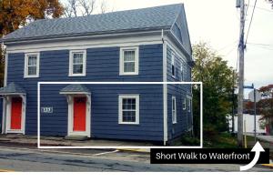 a blue house with a sign that says short walk to watford at Steps to the Waterfront in Shelburne