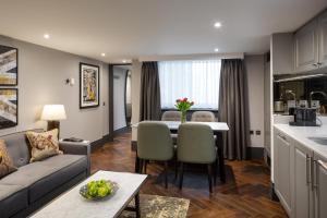a living room with a couch and a table at Hapimag Apartments London in London