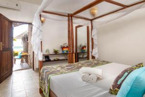 Postel nebo postele na pokoji v ubytování Mvuvi Boutique Resort