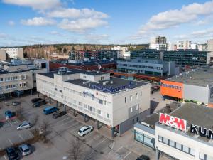 an aerial view of a city with buildings and a train at Hotelli Loimu in Raisio