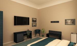 a bedroom with a bed and a desk and a television at Hotel Gran Bretagna Ortigia in Siracusa +28 photos