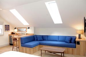 a living room with a blue couch and a kitchen at Best Bower in Portland