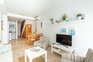 a living room with a couch and a table at Casa Colonia in Colonia Sant Jordi