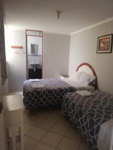 a hotel room with a bed and a mirror at La Posada de Valdez in Camaná +10 photos