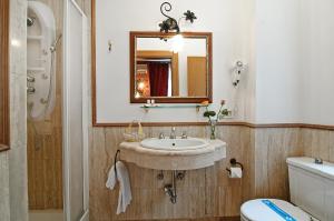 a bathroom with a sink and a mirror and a toilet at Residenza Antica Roma in Rome +23 photos