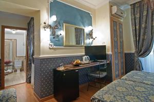 a hotel room with a desk in a bedroom at Residenza Antica Roma in Rome