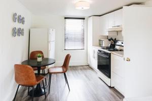 a kitchen with a table and chairs and a refrigerator at Sonoma's Best Guest Cottages in Sonoma