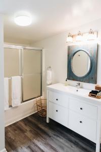 a white bathroom with a sink and a mirror at Sonoma's Best Guest Cottages in Sonoma +58 photos