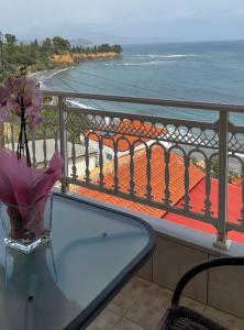 a table on a balcony with a view of the ocean at Sofotel in Koroni