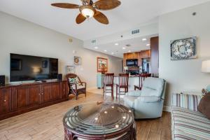 a living room with a couch and a ceiling fan at Sterling Breeze 903 in Panama City Beach