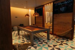 a ping pong table in a room with chairs at Emporio Cancun - Buy All Inclusive Option in Cancún