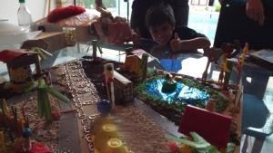 a boy is looking at a birthday cake with at Pousada Sitieto Voitov in Aluminio