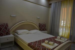 a bedroom with a bed with two bags on it at Mamas Reas in Káto Spílaion