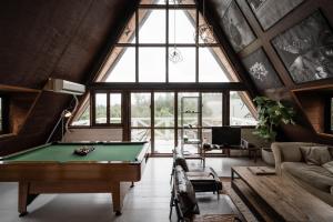 a pool table in a room with a large window at LOGIN OKINAWA -wood- in Onna