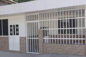 a building with white doors and windows on it at apartaestudio J.V.G. in San Andrés