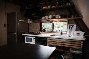 a kitchen with a sink and a refrigerator at LOGIN OKINAWA -soil- in Onna