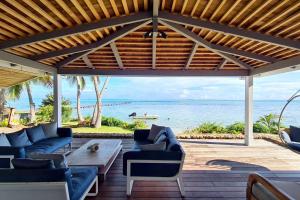 a patio with couches and a view of the ocean at Villa Oona in Maharepa