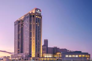 a tall building with lights on in a city at Grand Nikko Tokyo Daiba in Tokyo