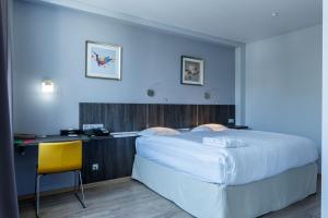 a bedroom with a large bed and a desk at Smart Hotel Bishkek in Bishkek +39 photos