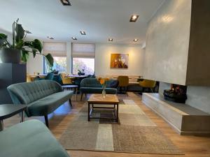 una sala de espera con sofás y chimenea en Hotel Zee Bergen, en Bergen