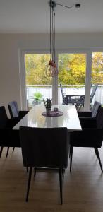a dining table and chairs in a living room at Ferienwohnung Selina in Losheim