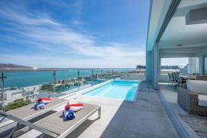 a balcony with a view of the ocean from a house at THE VIEW LANGEBAAN LAGOON VILLA WITH HEATED POOL and SOLAR ENERGY in Langebaan