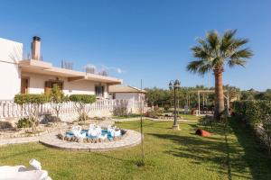 a house with a statue of people in a park at Fontana Holiday Home in Mouzákion