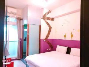 a room with a bed and a staircase in it at 花沐嵐民宿 in Taitung City