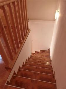 a staircase in a house with wooden floors and a light at Apartments Zukanovic in Fažana