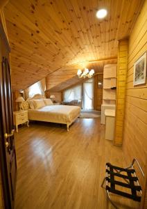 a bedroom with a bed and a wooden ceiling at Комплекс відпочинку GoldFіsh Сlub in Babintsy