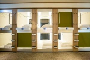 a room with bunk beds on a ship at Cabin & Capsule Hotel J-SHIP Osaka Namba in Osaka