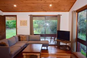 a living room with a couch and a tv at Shiralee's Rest of Katoomba in Katoomba