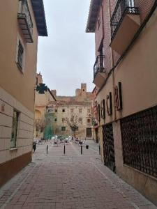 eine Kopfsteinpflasterstraße in einer Stadt mit Gebäuden in der Unterkunft Apartamentos El Cid in Molina de Aragón